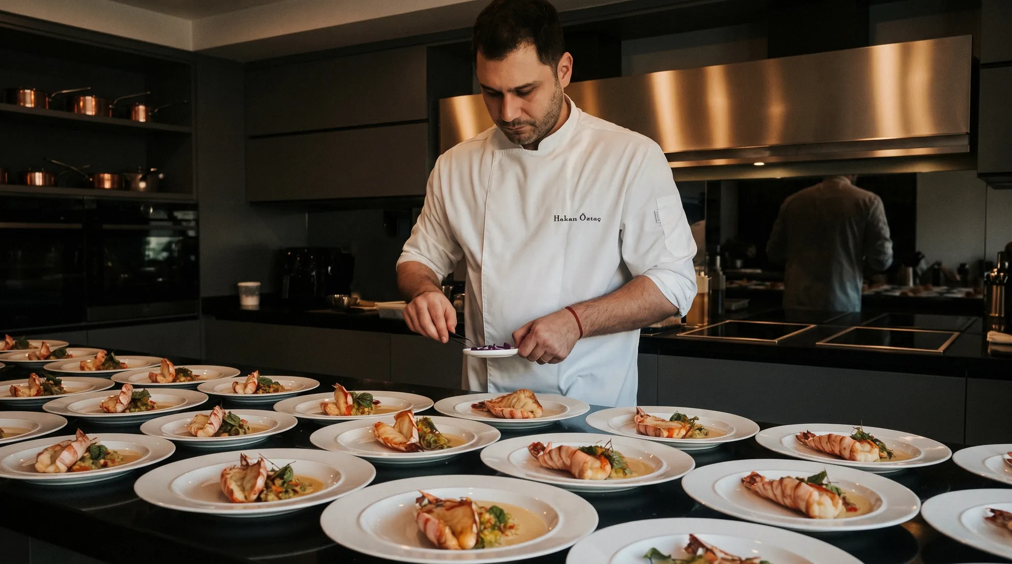 Chef Hakan Öztaç plating a full service at the pass